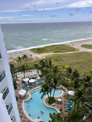 Room balcony view towards pool and ocean