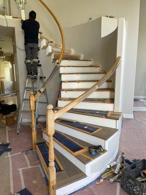 Engineered wood stair installation with white riser