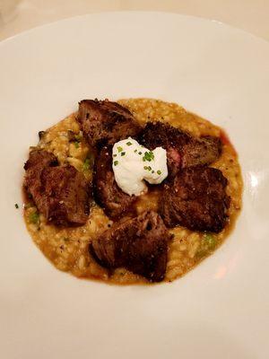 Beef tenderloin white truffle risotto with wild mushrooms, topped with goat cheese crema