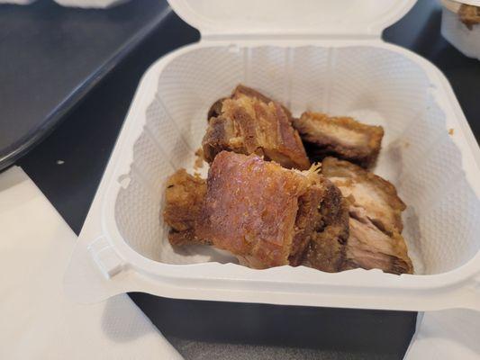 Lechon cut up into bite-sized pieces.