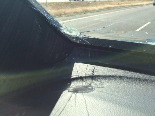 Glass inside vehicle on dashboard...would have been shards in my face if in the middle of the window.