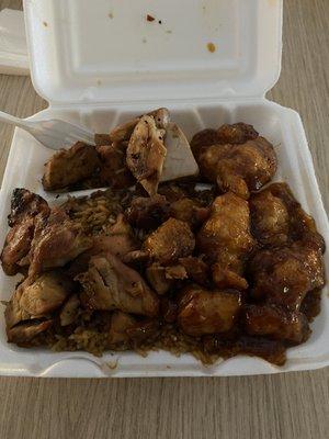 Two meat plate with bourbon chicken and honey chicken. The fried rice is under there.