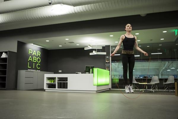 A snapshot of an Olympic figure skater jumping rope with a background view of our front desk/reception area.