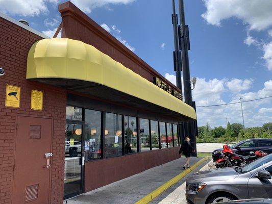 Outside of the Waffle House, next to the sedan/SUV