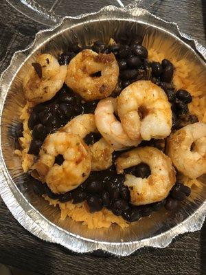 Shrimp with black beans and seasoned yellow rice.