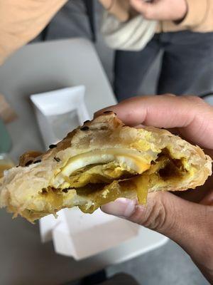 Inside of Curried onion and egg puff pastry (delicious)