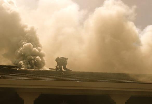 Firefighters who work on truck companies perform vertical ventilation in order to remove hot gas, and smoke from a residential house fire.