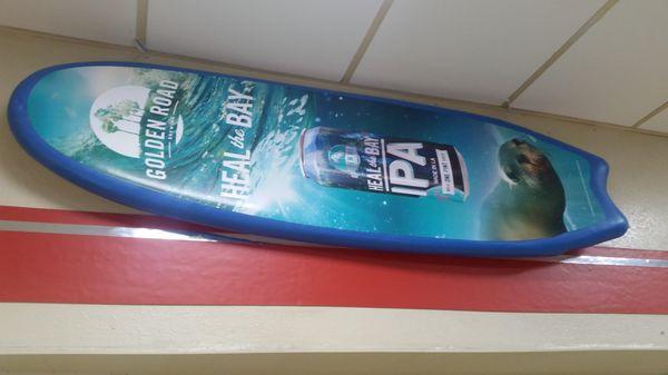 Cool surfboard mounted high on the wall.