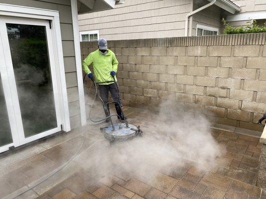 Steam power wash on a back patio