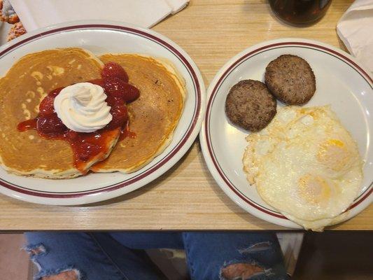 Strawberry and cream pancakes, with country sausage and medium cooked eggs