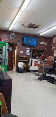 Good shop, old building, pop machine, tv