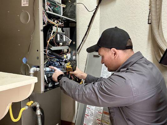 HVAC technician repairs furnace in private house in San Jose