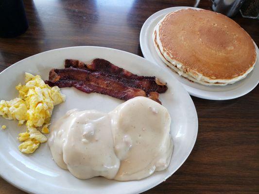 Half order of biscuits and gravy with bacon and a side of pancakes