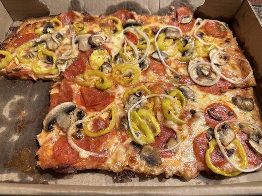 Pizza with pepperoni mushrooms onions and hot peppers