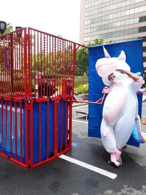 Unicorn pulling the lever on the dunk tank.