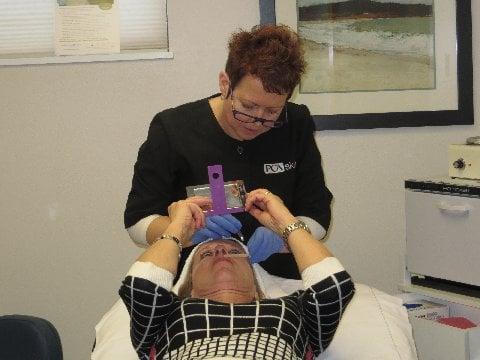 Kemmi Lee, our  and skin care expert performing a treatment.