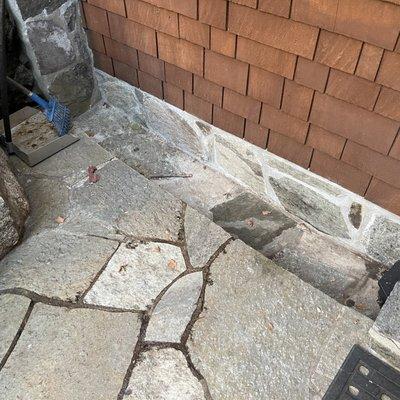 Drain channel next to garage step. They finished it with stone to match. Super nice job.