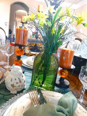 This beautiful tablescape is all about color and textures. Lovely jade vase, copper tone candles and a beautiful complimentary bird.