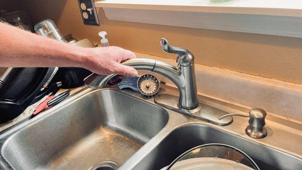 Kitchen sink faucet with sprayer replacement with under cabinet soap dispenser installation.