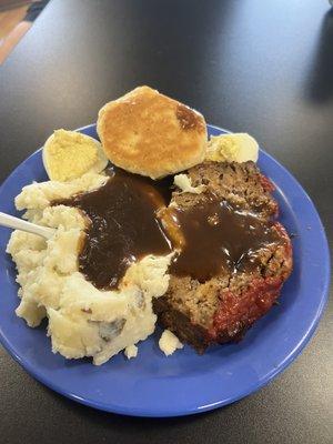 Meatloaf w/ mashed potatoes and gravy, deviled eggs and a biscuit.