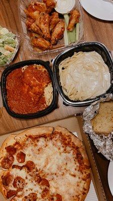 To-go order: Top: sesame wings with ranch 9/10 Middle: chicken parm, Alfredo pasta 9/10 Bottom: half pepperoni, half cheese pizza 8/10