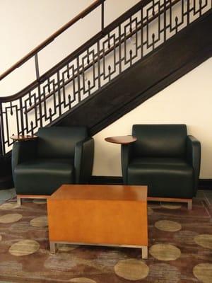 Cushioned chairs with laptop tables in the lobby