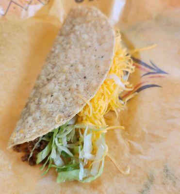 Beef taco with cheese and shredded lettuce