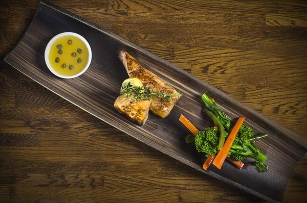 Salmão grelhado com molho de maracujá. Grilled salmon marinated with fresh herbs topped with a passion fruit reduction sauce.