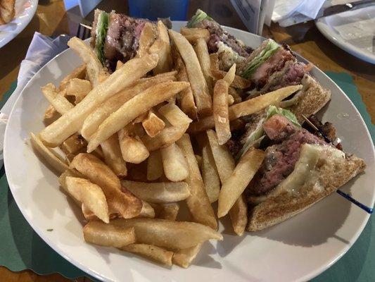 Cheeseburger club with fries.