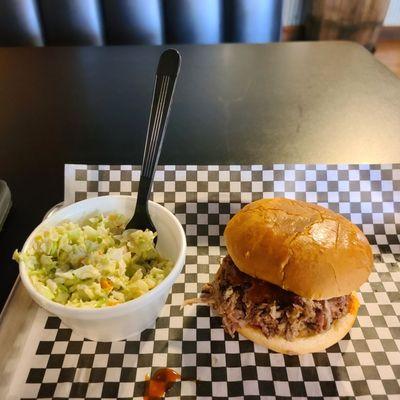 Chopped beef sandwich with coleslaw.