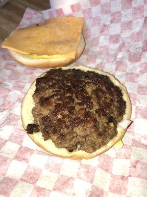 Cheeseburger with mustard, slaw and onions.