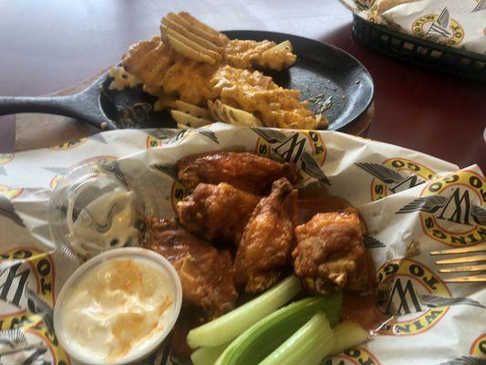 Wings with buffalo and garlic parm sauce waffle fries with cheez wiz and a buffalo parm cheese chicken wrap