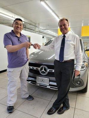 Dale handing me the keys to the most luxurious car I have ever owned.