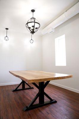 Custom conference table. Top is live edge White oak with steel trestle style legs.