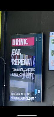 It's a sign to Drink and Repeat on the Sidewalk of 24th street