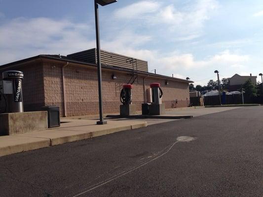 Car wash entrance and vacuum stations around back.