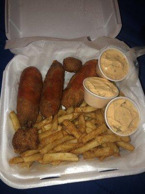 3 stuffed shrimp with fries, tartar sauce and hush puppies.