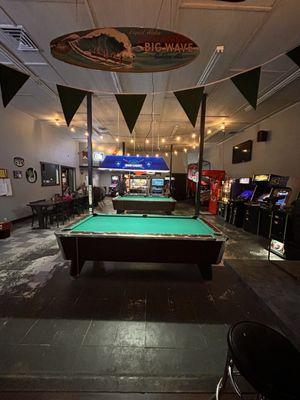 There is a pool hall with video games and more seating