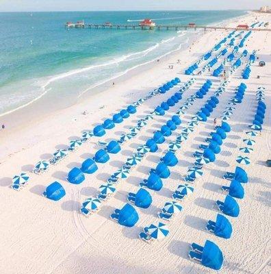 beach overrun with cabanas and umbrellas to rent