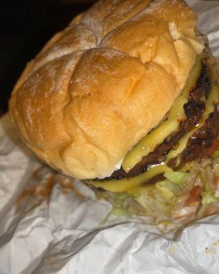 Double cheeseburger - vegan patty, vegan cheese, lettuce, tomato, grilled onions, & hot sauce.