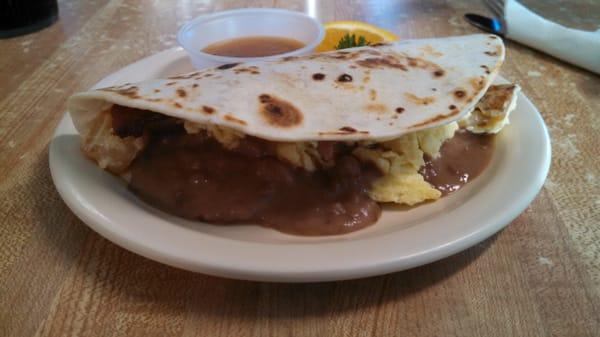 Potato, egg, bean and bacon taco with homemade salsa.