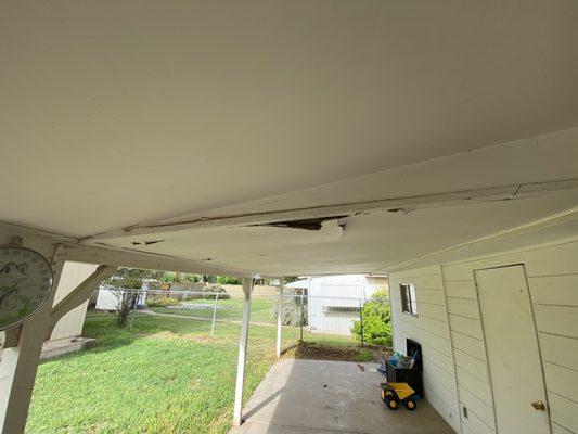 Water damage to porch leading to laundry access.