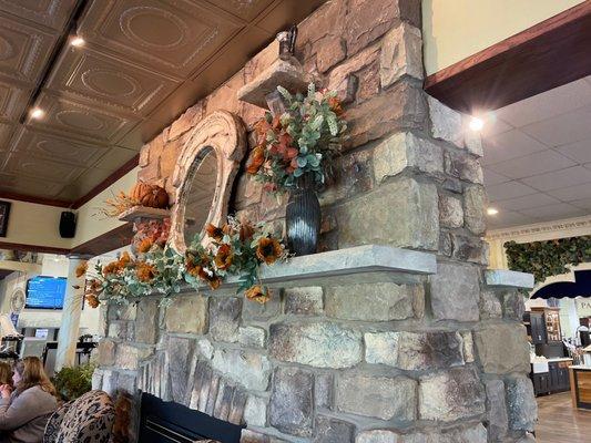 Lovely fall display on a beautiful stone fireplace