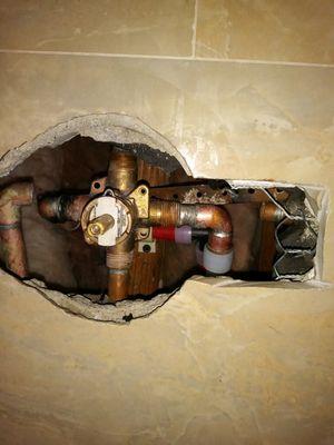 old copper lines cut away and new pex lines to shower valve added.