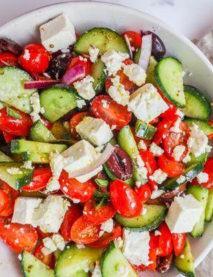 Greek Salad.
      Lettuce, tomato, cucumber, onion, olives and Feta, covered in our specially blended Greek dressing! Wow!