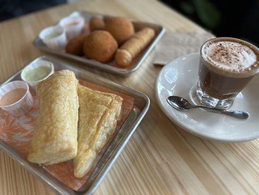 Clockwise:  (Sweet) Guava and cheese pastelito & guava pastelito (Savory) Ham croquetas, beef papa rellena, tequeño, choco bombon