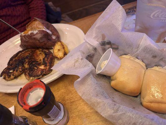 Herbed lemon chicken and baked potatoes with soft rolls