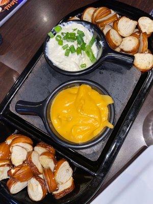 Pretzel bite appetizer with cheese and chive/sour cream based dips