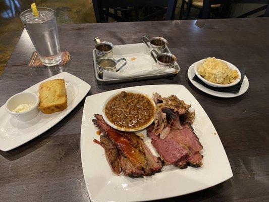 sweet and spicy cornbread. Main plate is Texas brisket, pastrami, and pork shoulder. Upper right is Gouda mac n cheese.