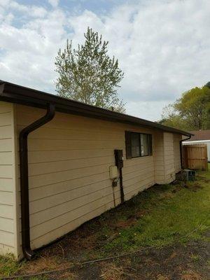 Brown 6" seamless gutter with 3x4 downspout.